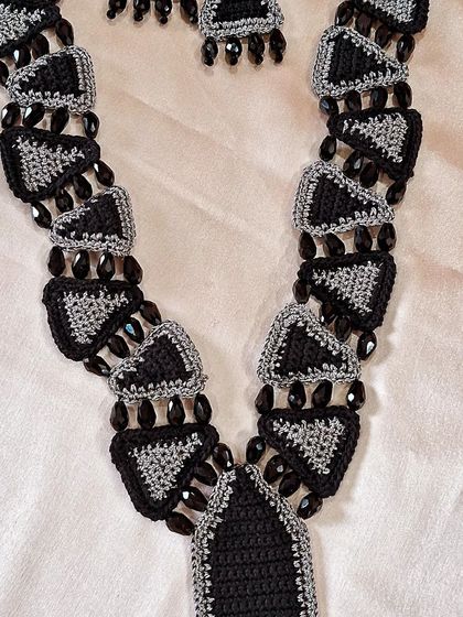 The full view of our geometric statement necklace, a piece that took patience and precision to create. The repeating triangular motifs create a powerful and rhythmic design.