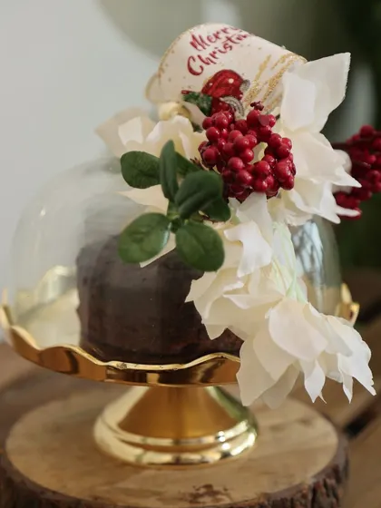 Our Gold Scallop Dessert Stand, decorated for Christmas with a festive plum cake and a beautiful floral arrangement. This shows how our pieces can be styled for any holiday.