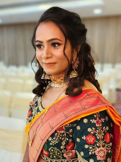 A dewy golden glow for this reception look. The makeup is warm and radiant, perfectly complementing the bride's yellow and green outfit.