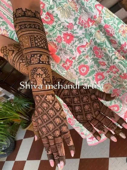 A beautiful design featuring a lotus grid pattern on the palms, which is both traditional and elegant. The forearms have bands of different intricate patterns.