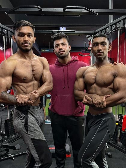 Posing with my clients, who are both dedicated students preparing for the stage. One is aiming for a lean aesthetic, the other for massive size.