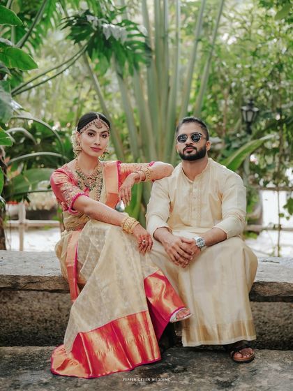 A stylish portrait of the couple seated in a garden, their poses exuding confidence and elegance.