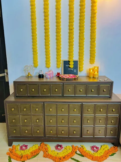 Our Treasure Console, styled beautifully for a festive occasion. This piece features numerous small drawers with classic knobs, offering an apothecary-style look that is both charming and practical for storage.