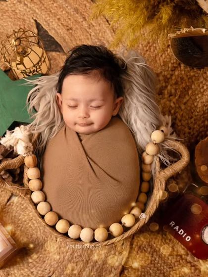 A similar top-down shot of another baby in the same boho basket setup, showing how we customize small details for each session.