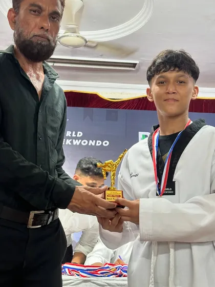 Congrats to our winner, proudly receiving his trophy at a Taekwondo competition.
