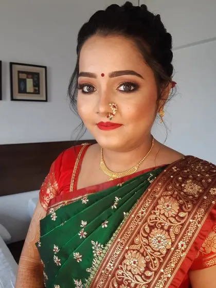 I have a special love for creating the perfect Marathi bridal look. This features classic soft glam makeup with a traditional nath and bindi, paired with an elegant braided hairstyle that is both beautiful and secure.
