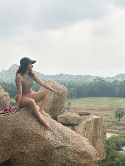 Taking a break on top of a boulder to soak in the incredible landscape of Hampi. The view from the top is always worth the climb.