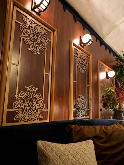 A close-up of the custom-designed gold cutwork panels that adorned the walls of the train compartments, adding a touch of Indian-inspired artistry to the vintage theme.