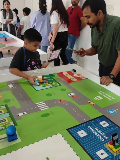 A parent and child work together during one of our internal robotics competitions. These events help students build confidence and test their skills in a friendly, supportive environment.