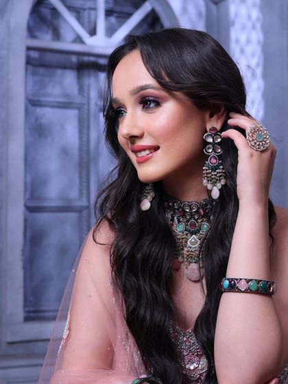 This angle shows off the beautiful, soft waves in her hair and the intricate details of her earrings and necklace.