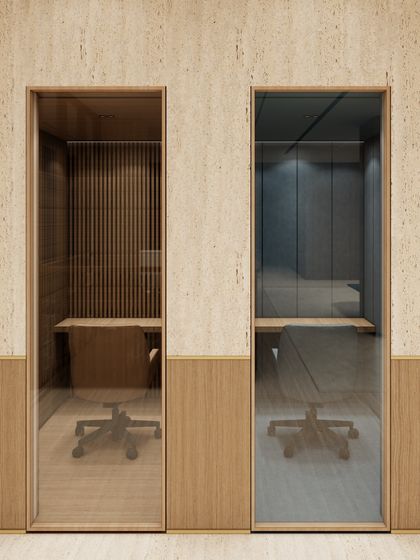 This render shows our design for private phone booths, offering soundproofed, quiet zones within an open-plan office. We used distinct materials like fluted wood and darker tones to visually separate these focus areas from the more collaborative spaces.