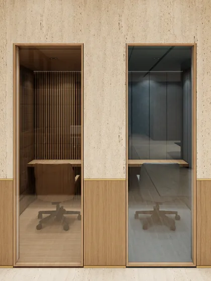 This render shows our design for private phone booths, offering soundproofed, quiet zones within an open-plan office. We used distinct materials like fluted wood and darker tones to visually separate these focus areas from the more collaborative spaces.