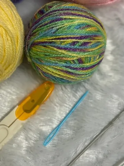 Here is a close-up of the high-quality materials from my beginner's kit. You get soft yarn in beautiful colors, two different crochet hooks for various projects, safety eyes for your plushies, and a handy pair of scissors.