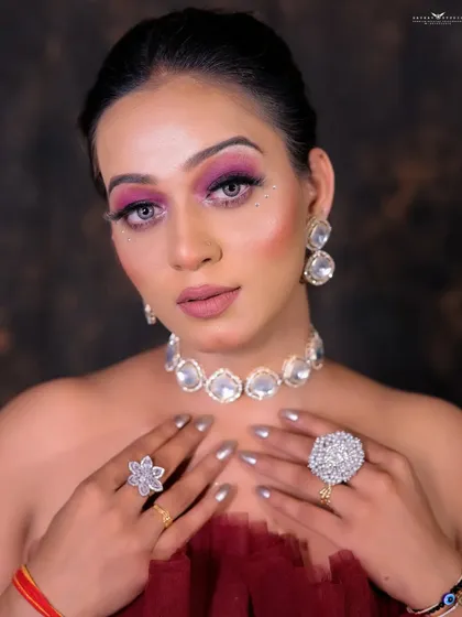 A close-up focusing on the statement diamond jewelry and the model's flawless makeup.