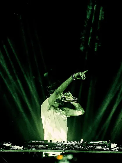 Pointing to the crowd under green spotlights. It's a simple gesture, but it's how I connect with people and make them feel part of the show.