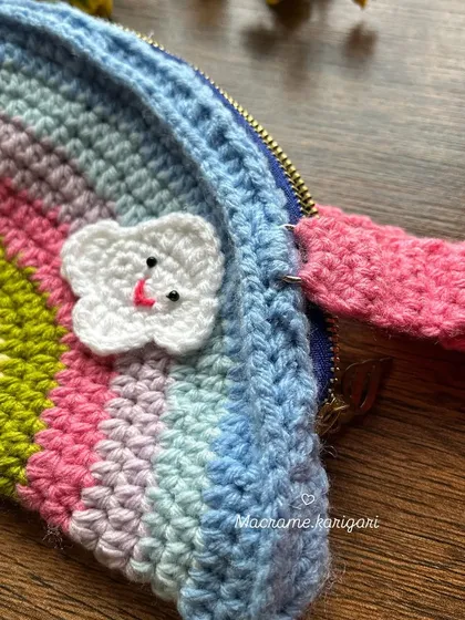 A detail shot of the strap attachment and the happy cloud appliqué. We use quality hardware to ensure our bags are durable for kids.