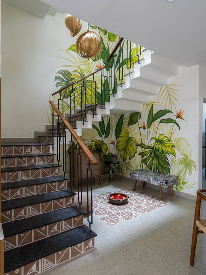 The full view of the Mathrukrupa staircase, a perfect example of how we use art, materials, and lighting to transform a functional area into a stunning feature.