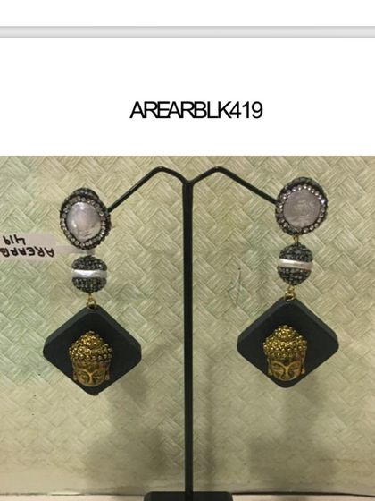 A pair of unique statement earrings featuring a Buddha motif. These accessories are perfect for adding a special touch to an Indo-Western or ethnic outfit.