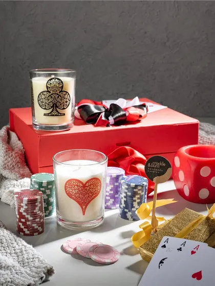 Perfect for your Diwali card parties, this poker-themed gift set is always a hit. It includes glass candles printed with card suits and a fun dice-shaped candle holder, all ready to gift in a bright red box.