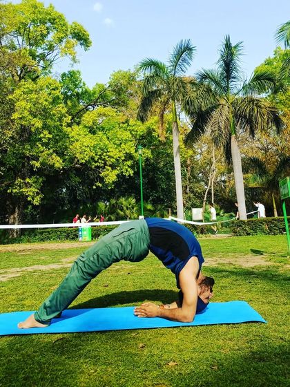 Here I am in Dwi Pada Viparita Dandasana, an advanced backbend on the forearms. This pose deeply opens the chest and strengthens the shoulders.