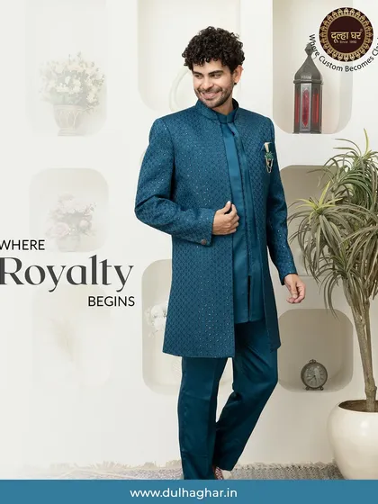 This striking teal Indo-Western sherwani is where royalty begins. The rich, textured fabric and long, structured silhouette offer a modern take on traditional groomswear, perfect for making a grand entrance.