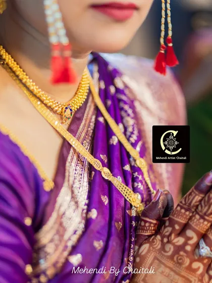 A detailed shot focusing on the bridal jewelry and the mehendi stain on her hands. Every element comes together to create a timeless bridal look.