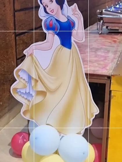 A life-sized cutout of Snow White, used as a prop for a Disney princess themed party.