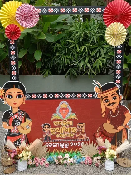 A beautiful photo booth for a traditional Nuakhai Juhar celebration. The frame features cultural illustrations and is decorated with paper fans and flowers, blending tradition with fun.