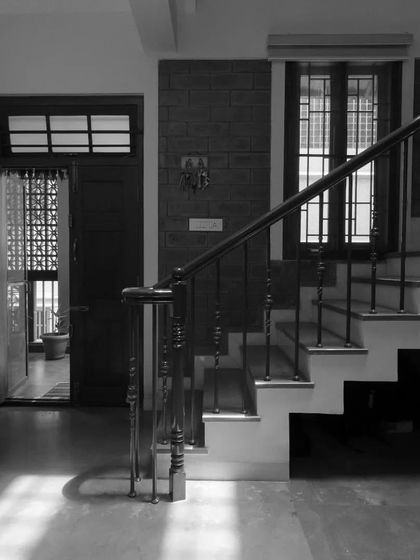 The play of light and shadow at the entrance, where sunlight streams across the floor, highlighting the textures of the space and creating a warm welcome.