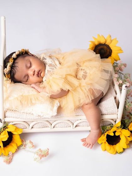 A sunshine girl surrounded by sunflowers. This bright and cheerful setup is perfect for a baby born in the summer or for parents who love vibrant colors.