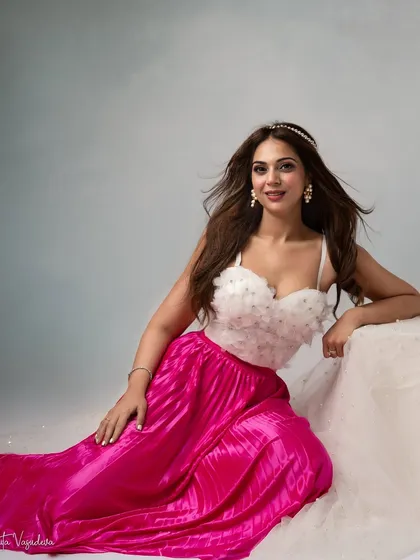 A pop of color for her birthday celebration. The bright pink skirt paired with a delicate white top and tiara creates a look that is both fun and princess-like.