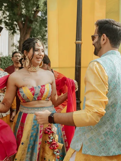 The happy couple enjoying a dance during their Haldi ceremony. Our decor creates the perfect vibrant backdrop for these joyful, candid moments.