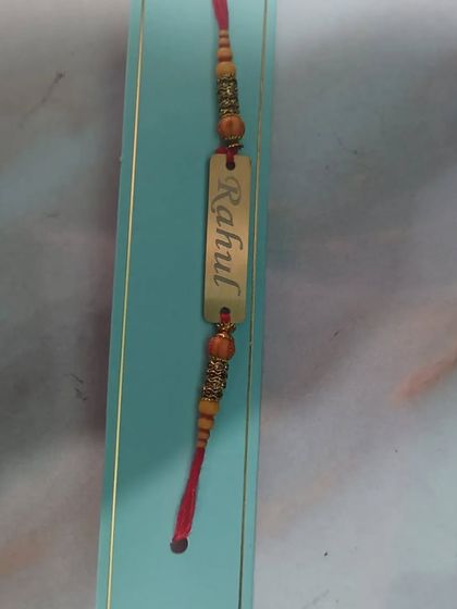 The sleek and durable metal name Rakhi, engraved with 'Rahul'.