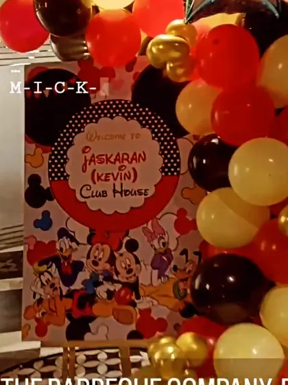 A closer look at the custom welcome sign for the Mickey Mouse Clubhouse party, surrounded by a cascade of colourful balloons.