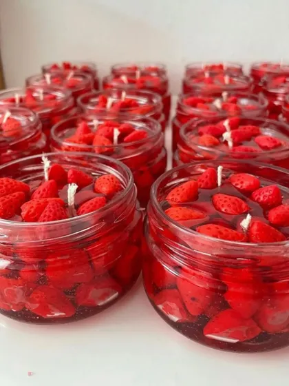 A close-up of my strawberry dessert candles, ready for gifting. These jars are filled with wax strawberries, creating a vibrant and tempting look that's perfect for anyone with a sweet tooth.