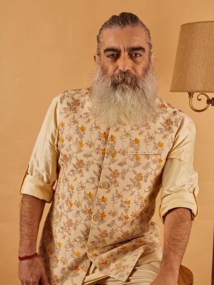 A seated portrait in our floral vest and kurta set. The comfortable fit and breathable fabric make it an ideal choice for long hours of celebration.