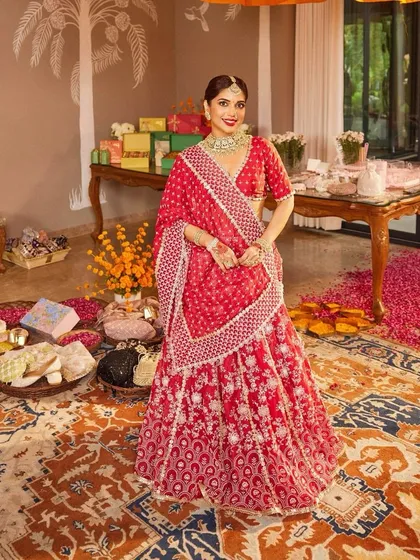 The bride, Samiksha Pednekar, looking absolutely radiant in a red lehenga, ready for her big day. This is what main character energy looks like.