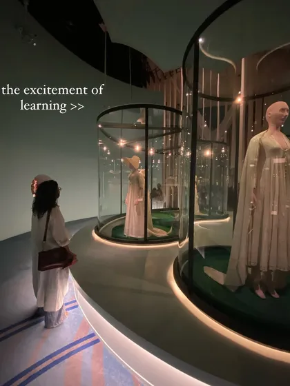 The excitement of learning is everything. Here I am at a fashion exhibit, soaking in the inspiration and history behind the designs.