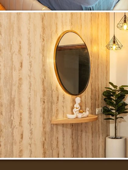 The foyer of the Brigade Cornerstone Utopia apartment, with a textured wallpaper and an elegant backlit mirror.