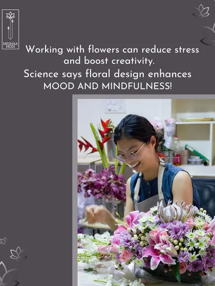 A student smiles, surrounded by flowers. Science says floral design enhances mood and mindfulness, and my hobby classes are a perfect example of this creative boost.