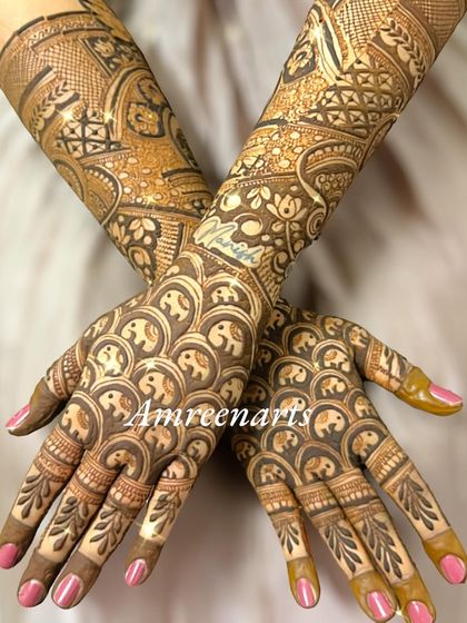 The back of the hands, covered in a playful pattern of repeating baby elephants.