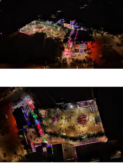 A high-altitude aerial view of a large, brightly lit event venue at night. This shot is ideal for showcasing the full scale and layout of a property.