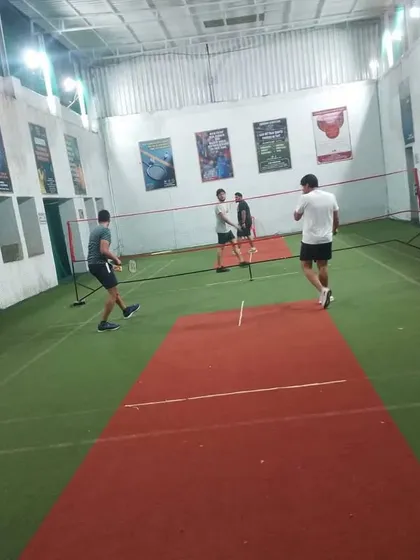 Players strategizing between points. Communication with your partner is key to winning in doubles.