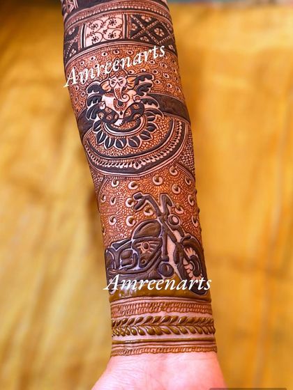 A unique arm design combining a portrait of Lord Ganesha with a detailed sketch of a Harley Davidson motorcycle.