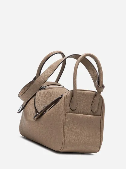 The back view of the Linde Large bag, showing the clean lines and the convenient outer pocket. The pebbled leather texture is visible across the entire surface.