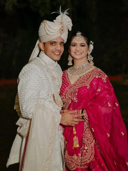 A happy couple shot. The bride's makeup is designed to look flawless both in person and in photographs, ensuring she looks her best from every angle.