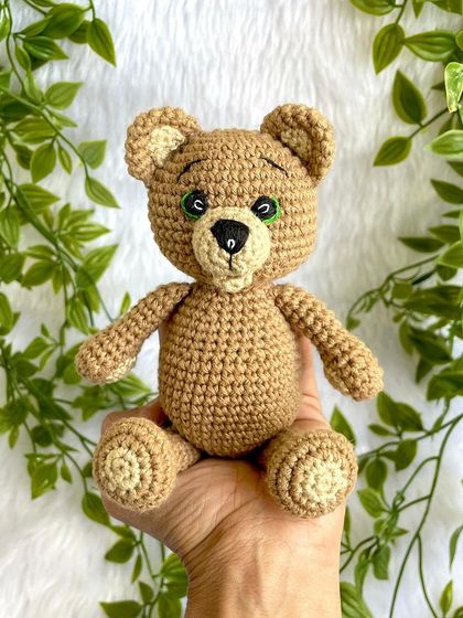 A classic teddy bear, a timeless gift for any age. This one is shown with a red ribbon, a black tie for 'Daddy Bear', and with expressive green eyes. They are soft, cuddly, and made to be loved.