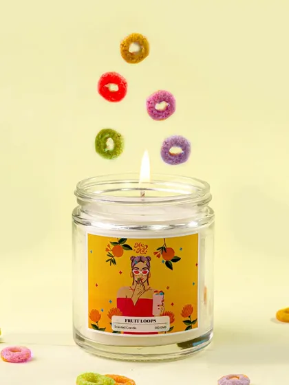 Levitating fruit loops appear to dance above the lit candle, adding a touch of magic and motion to this fun and colorful shot. It’s a creative way to express the candle's playful energy.