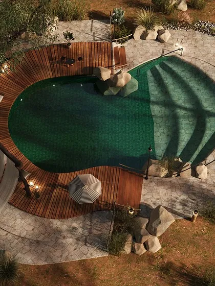 From above, you can see how the pool was designed to mimic a natural lagoon. The curved wooden deck and scattered boulders blur the lines between the man-made structure and the wild landscape, offering guests a place to connect with water in a pure, organic setting.