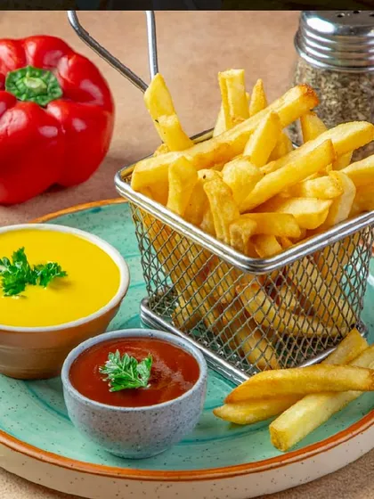 Cheesy French Fries are all you need for a perfect snack. My fries are crispy and served with a delicious cheese dip and ketchup.